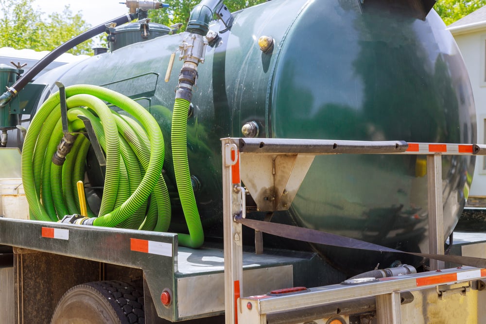 Septic Pumper Truck Parked Outside a House